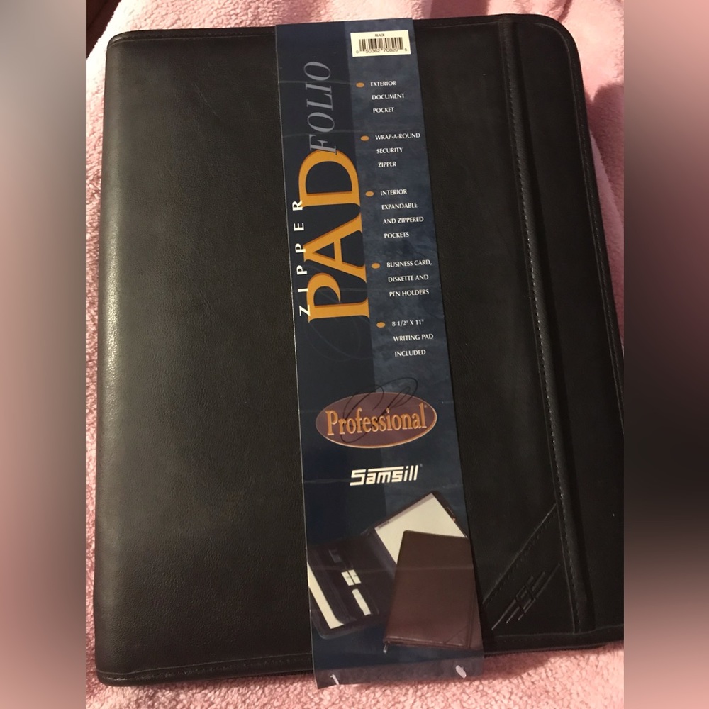 Black portfolio with wraparound zipper. Writing pad, slide and zippered pockets.